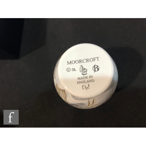 75 - A Moorcroft Enamels vase decorated with two hand painted robins amidst snow, printed mark, boxed, he... 