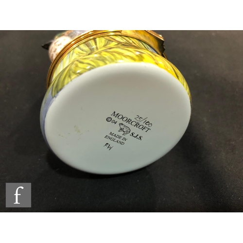 78 - A Moorcroft Enamels and Bronte Porcelain trinket box and cover, the lid with a porcelain model of a ... 