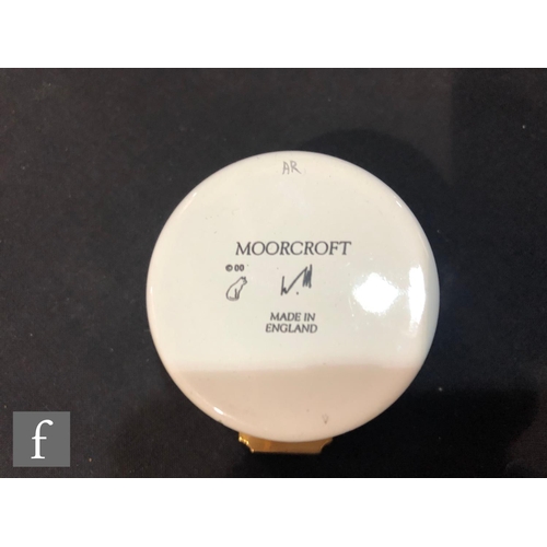 79 - A Moorcroft Enamels trinket box and clock, the body and cover decorated with purple flowers over the... 