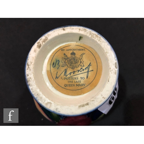 99 - A small Moorcroft vase of footed bulbous form decorated in the Frilled Orchid pattern, any marks obs... 