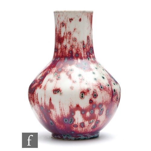 132 - Ruskin Pottery - A high fired vase of angular form decorated in an all over sang de beouf glaze with... 