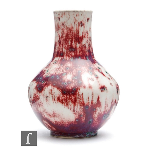 132 - Ruskin Pottery - A high fired vase of angular form decorated in an all over sang de beouf glaze with... 