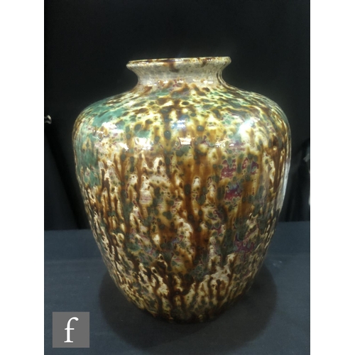 110 - Ruskin Pottery - A large high fired barrel vase with a squat flared collar neck decorated with brown... 