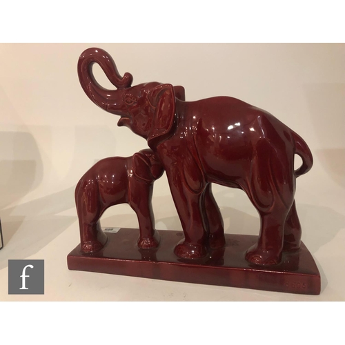 808 - Charles Lemanceau - An Art Deco model of an elephant and her calf, both glazed in red, on a rectangu... 