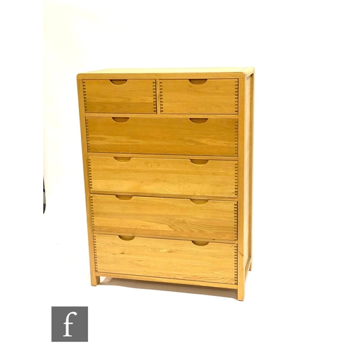 1496 - Ercol Furniture - A light oak Bosco range chest of two short over four long drawers, with curved fin... 