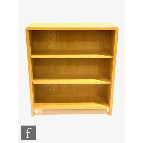 1500 - Ercol Furniture - A light oak Bosco range open fronted bookcase, with curved finger joint detailing ... 