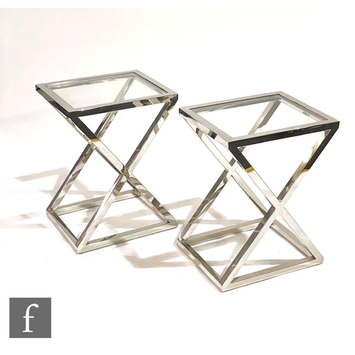 1512 - Eichholtz - A pair of 'Criss Cross high steel' side tables, the X frame aluminium table with upper g... 