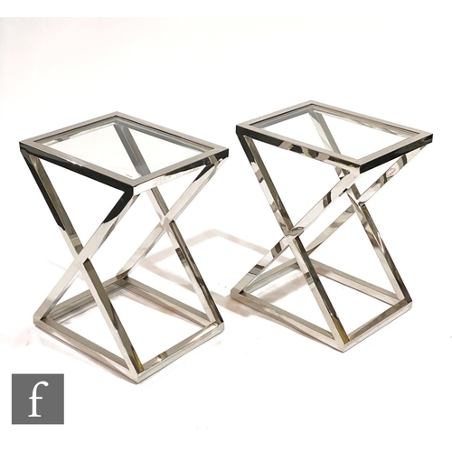 1513 - Eichholtz - A pair of 'Criss Cross high steel' side tables, the X frame aluminium table with upper g... 