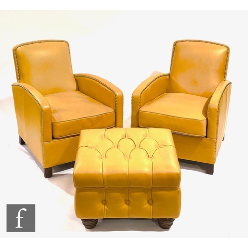 1514 - Timothy Oulton - A pair of mustard leather studded armchairs on dark wood block feet, each bearing U... 