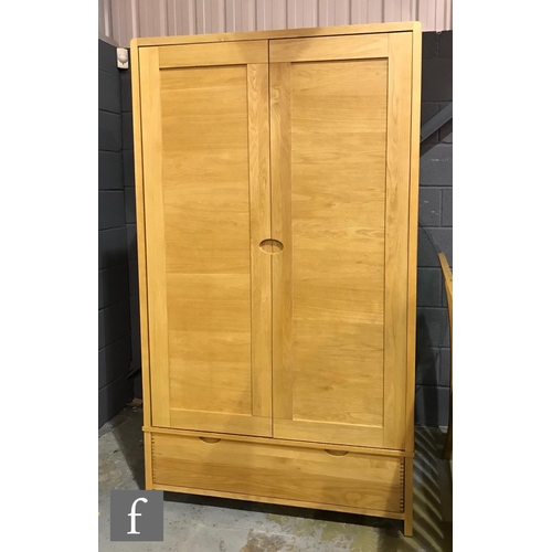 1498 - Ercol Furniture - A light oak Bosco range wardrobe, fitted with double doors above a drawer to the b... 