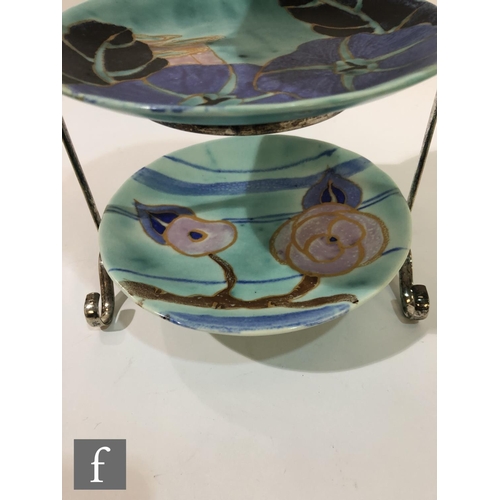 488 - Clarice Cliff - Inspiration - A three tiered chrome plated cake stand circa 1930, with three differe... 