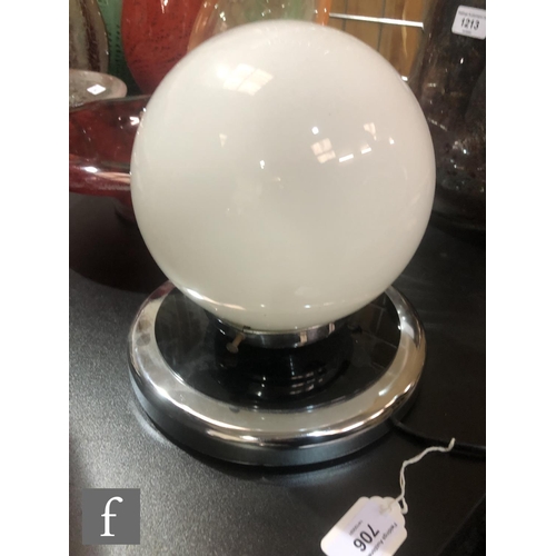 706 - Unknown - An Art Deco lamp with a spherical opaline glass shade with a wide mirror and black acrylic... 