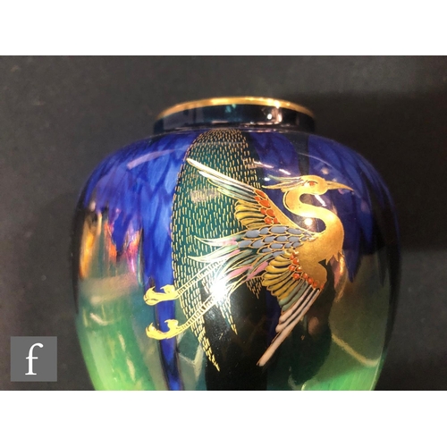 560 - Carlton Ware - A pair of Art Deco vases decorated in the Heron and Magical Bird pattern, printed scr... 