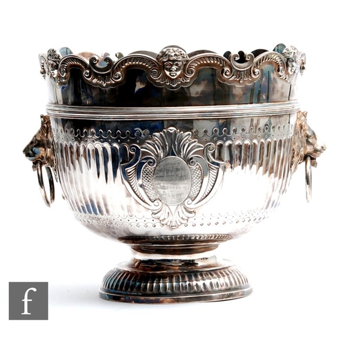 100 - A hallmarked silver twin handled punch bowl with fluted foot and body flanked by lion masked ring ha... 
