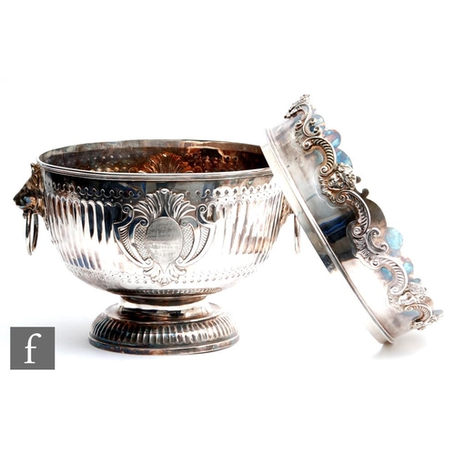 100 - A hallmarked silver twin handled punch bowl with fluted foot and body flanked by lion masked ring ha... 