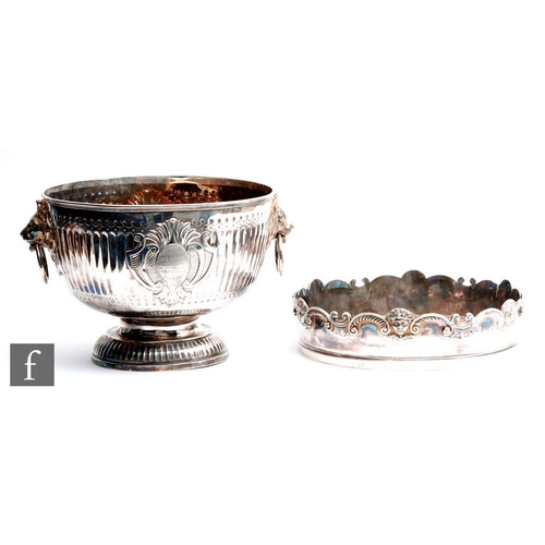 100 - A hallmarked silver twin handled punch bowl with fluted foot and body flanked by lion masked ring ha... 
