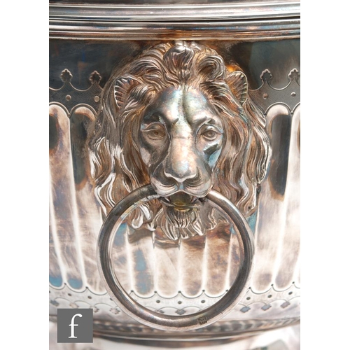 100 - A hallmarked silver twin handled punch bowl with fluted foot and body flanked by lion masked ring ha... 
