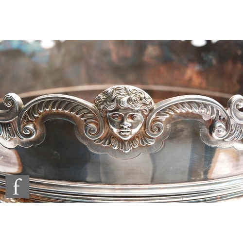 100 - A hallmarked silver twin handled punch bowl with fluted foot and body flanked by lion masked ring ha... 