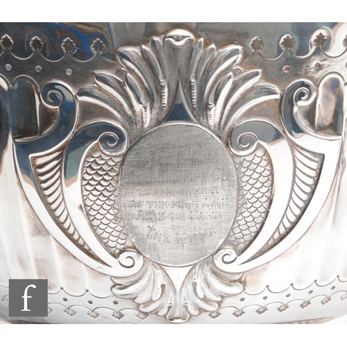 100 - A hallmarked silver twin handled punch bowl with fluted foot and body flanked by lion masked ring ha... 