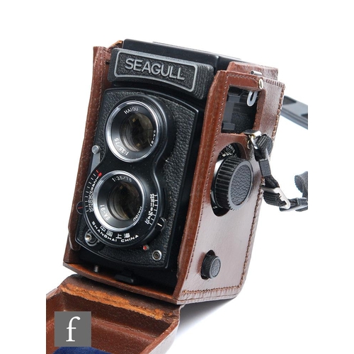 211 - A Seagull TLR camera, serial number 03558, with original leather fitted case.