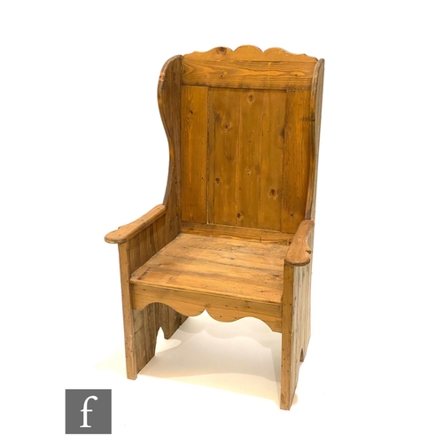 1148 - A 20th Century pine lambing chair, high back, shaped arms and open ends, height 122cm.