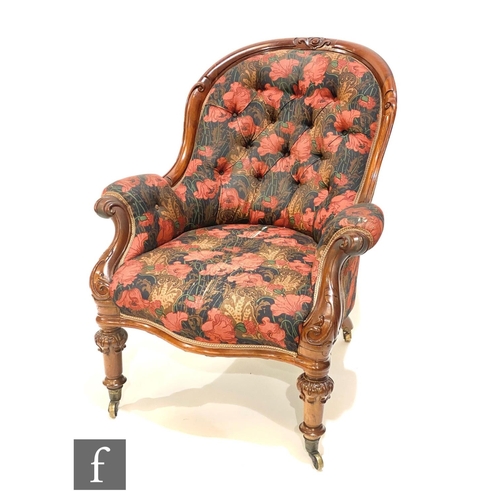 1153 - A Victorian mahogany open scroll arm chair on turned carved legs, upholstered in a printed poppy des... 