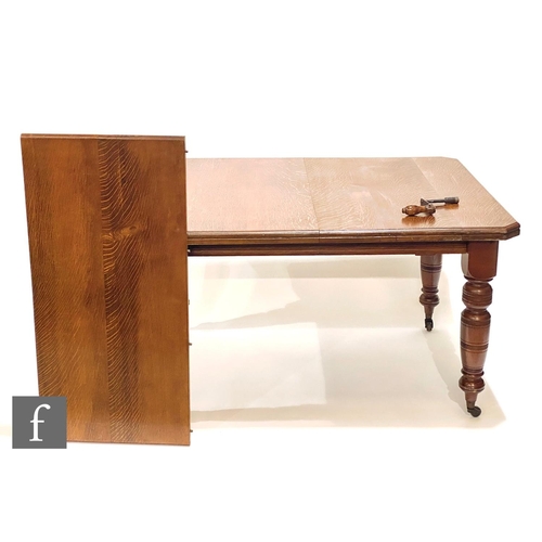 1166 - An early 20th Century oak extending dining table with single insert leaf, the top with canted corner... 