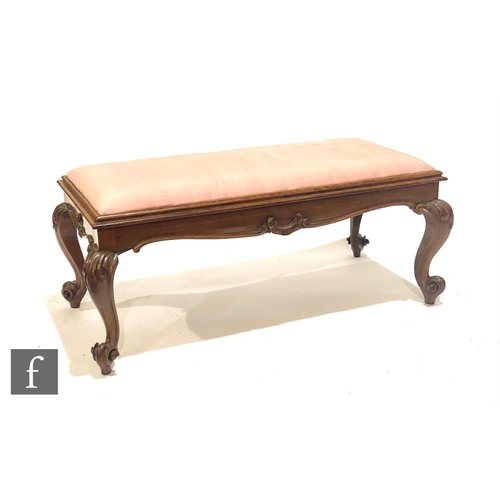 1144 - A Victorian rosewood duet music stool of rectangular form, with lift up seat over scroll carved legs... 