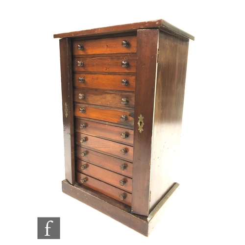 1168 - A late 19th to early 20th Century stained pine collectors cabinet in the form of a Wellington chest,... 