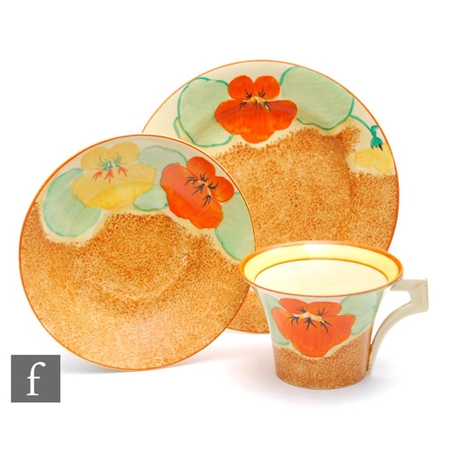 287 - Clarice Cliff - Nasturtium - A Daffodil shape tea cup, saucer and side plate circa 1936, hand painte... 