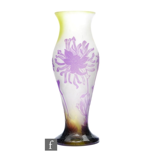 4 - Andre Delatte - An early 20th Century cameo glass vase of baluster form, cased in purple over an opa... 