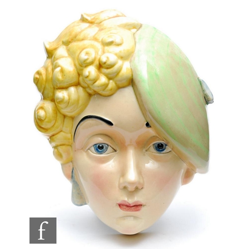 393 - Beswick Pottery - A 1930s Art Deco face mask modelled as a young girl with curled blonde hair and a ... 