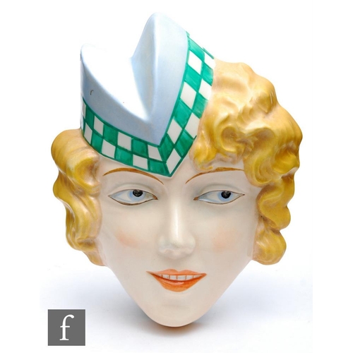 396 - Attributed to Royal Dux - A wall mask modelled as a lady wearing a peaked hat in blue with green and... 