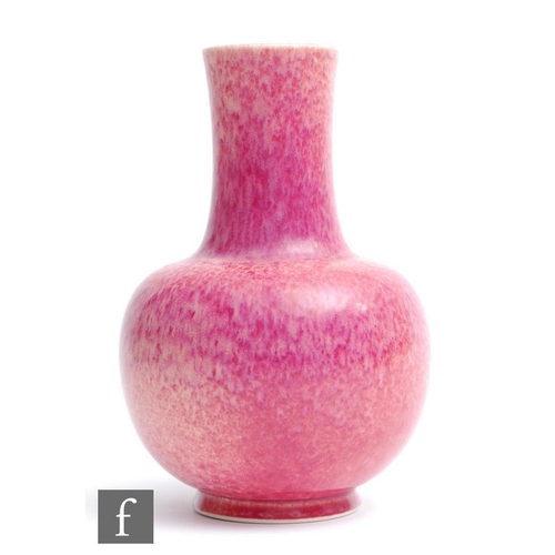 60 - Ruskin Pottery - A vase of globe and shaft form decorated in an all over Strawberry Crush glaze with... 