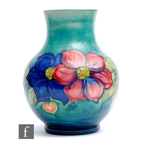 63 - William Moorcroft - A large vase of footed globe and shaft form decorated in the Clematis pattern wi... 