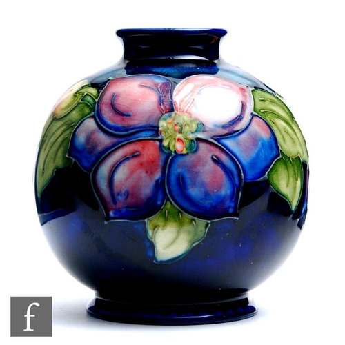 66 - William Moorcroft - A small footed ovoid vase decorated in the Clematis pattern, impressed mark, hei... 