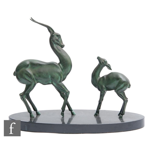 541 - Unknown - An Art Deco green patinated spelter study, circa 1935, of a standing stylised gazelle with... 