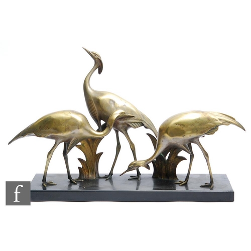 568 - Armand Sinko - A French Art Deco bronze study of three stylised cranes in various poses, mounted on ... 