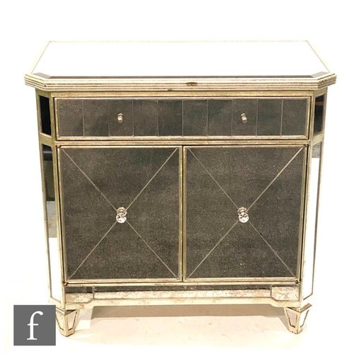 1183 - Unknown - A contemporary small mirrored cabinet, the canted top with gilt edging, the single drawer ... 