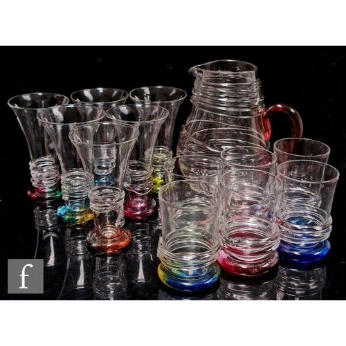 1223 - Bob Crooks - A contemporary glass drinking suite in the Rainbow Ripple pattern, decorated in clear g... 