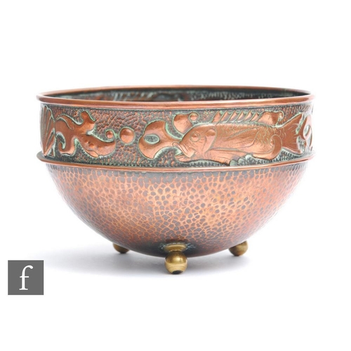 34 - Herbert Dyer - An Arts and Crafts copper bowl decorated with a band of fish and shells with planishe... 