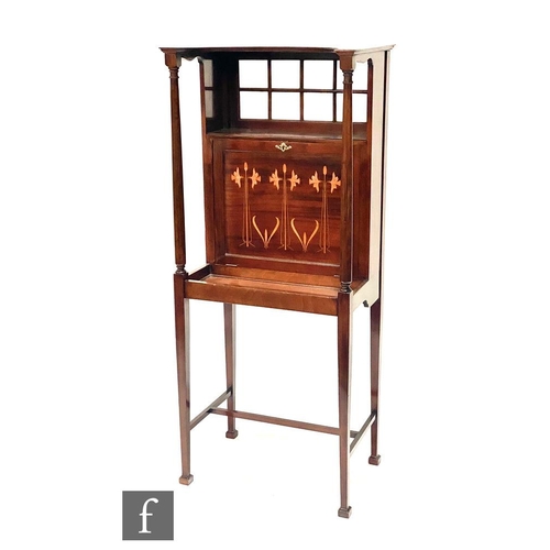 48 - Liberty & Co - A mahogany writing cabinet, the canopy top over a sectional glazed panel and a fa... 