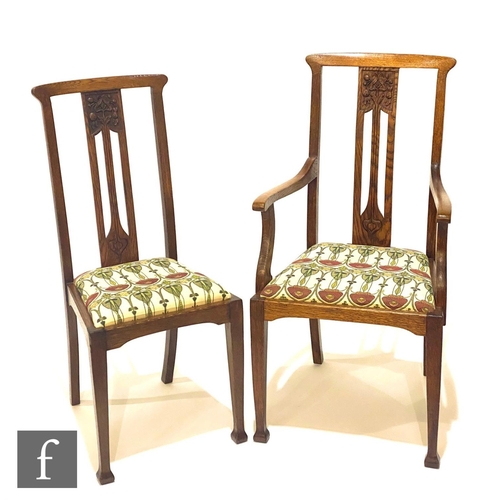 45 - In the manner of Liberty & Co - A set of six oak dining chairs, the pierced backs with carved st... 