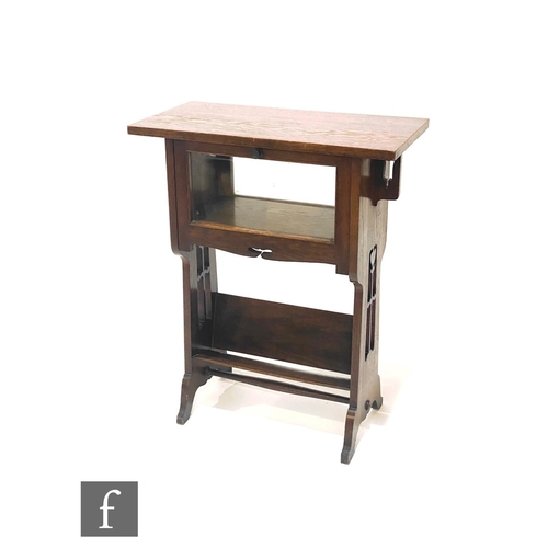 46 - In the manner of Liberty & Co - A small oak cabinet bookcase, the rectangular overhanging top ab... 