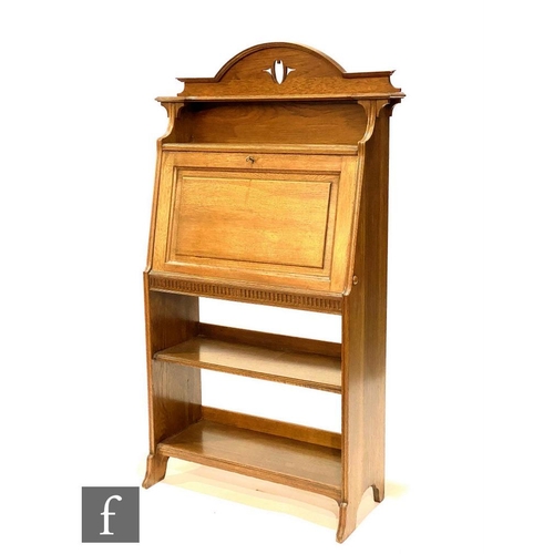 49 - In the manner of Liberty & Co - An oak combination fall front bureau bookcase, the upper section... 