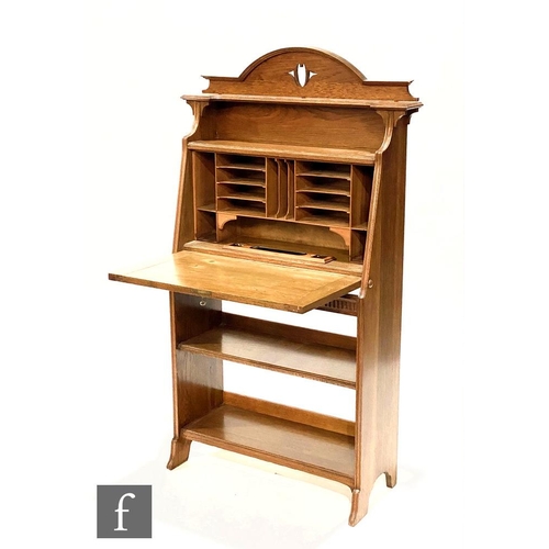 49 - In the manner of Liberty & Co - An oak combination fall front bureau bookcase, the upper section... 