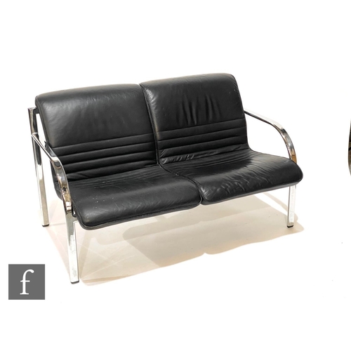 1232 - Dauphin Furniture, Germany - A black leather two seat sofa with chromium plated flattened tubular fr... 