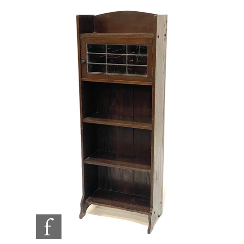 47 - Unknown - An Arts and Crafts oak cabinet bookcase, with galleried shelf above a leaded glazed door a... 