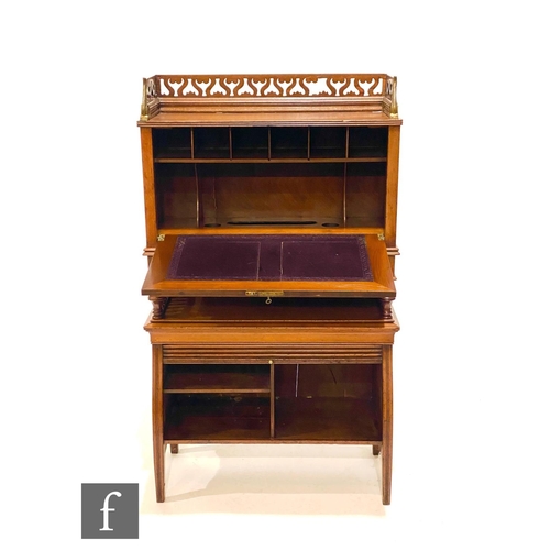 51 - James Shoolbred - A students walnut combination writing desk and bookcase, with fret-cut gallery ove... 