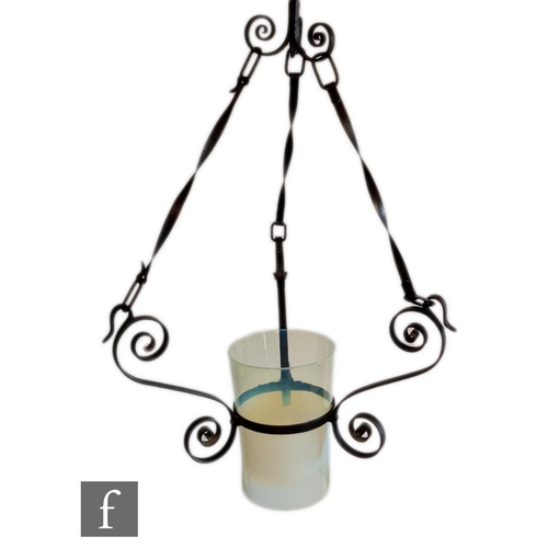 40 - James Powell & Sons - An Arts and Crafts hanging lantern, with a wrought iron scroll frame and a... 